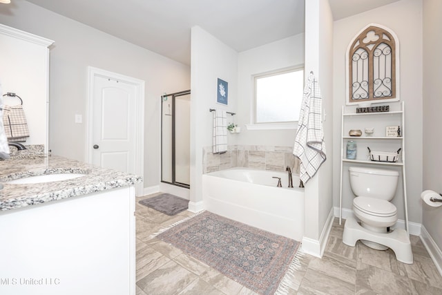 full bathroom featuring shower with separate bathtub, vanity, and toilet