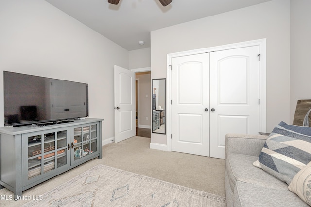 carpeted living room with ceiling fan