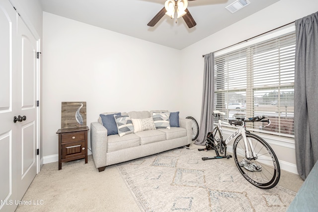 carpeted living room featuring ceiling fan