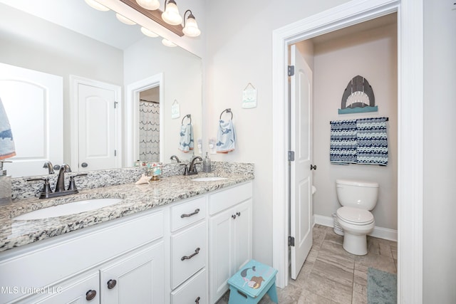 bathroom featuring vanity and toilet