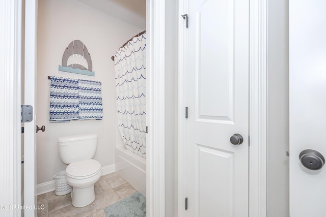 bathroom featuring shower / tub combo, tile patterned flooring, and toilet