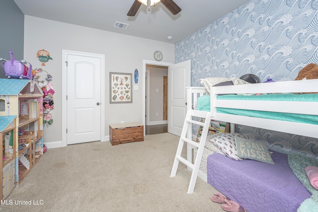 bedroom with ceiling fan and light carpet