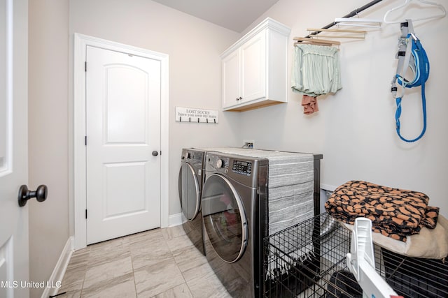 washroom featuring cabinets and washer and dryer