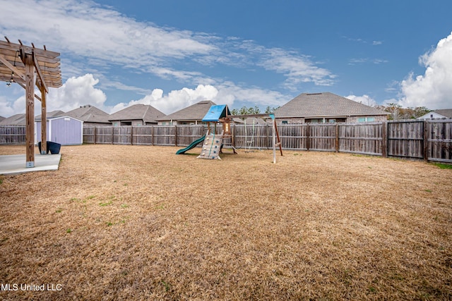 view of yard with a playground and a storage unit