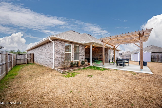 rear view of property featuring a shed, a pergola, and a patio area