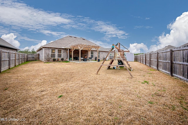 view of yard with a playground, a patio, and a pergola