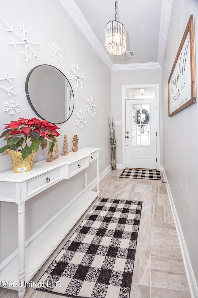 foyer entrance featuring ornamental molding and a notable chandelier