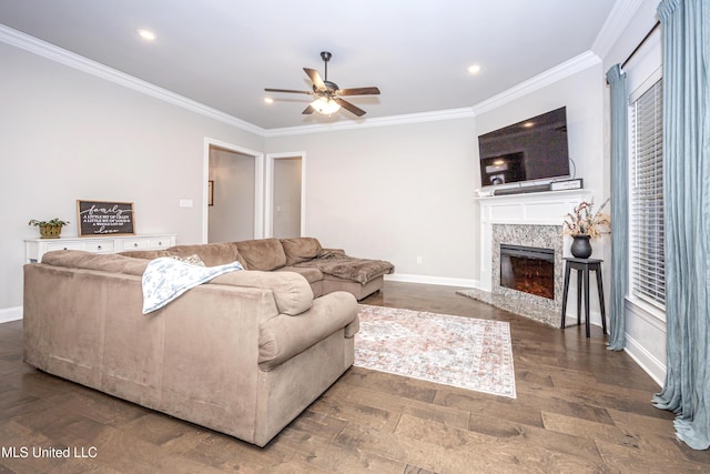 living room featuring crown molding, a fireplace, dark hardwood / wood-style floors, and ceiling fan