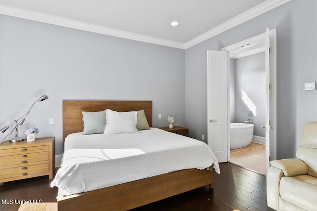 bedroom with dark wood-type flooring, ornamental molding, and connected bathroom