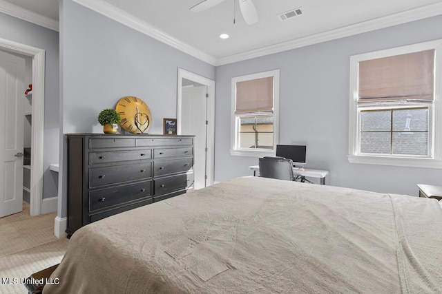 carpeted bedroom featuring ceiling fan and crown molding