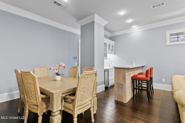 dining space featuring dark hardwood / wood-style floors and crown molding