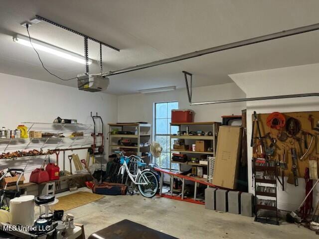 garage with a garage door opener and a workshop area