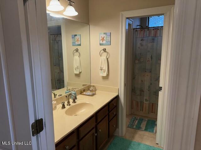 bathroom featuring vanity, tile patterned flooring, and a shower with curtain