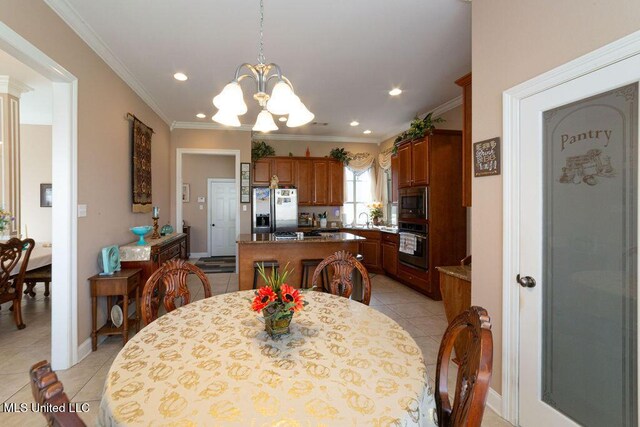 dining area with ornamental molding, sink, light tile patterned floors, and a notable chandelier