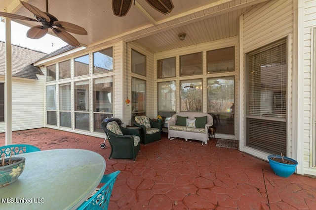 sunroom featuring ceiling fan