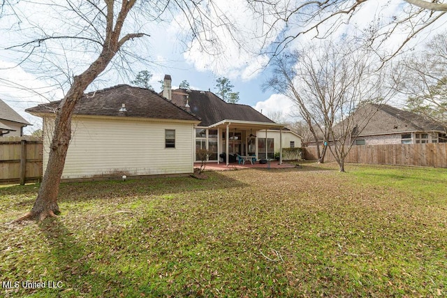 back of house featuring a yard and a patio area