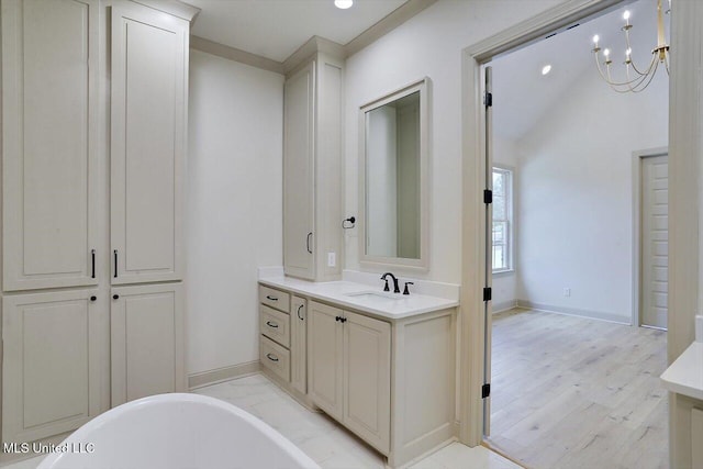 bathroom featuring a bathing tub, vanity, wood-type flooring, and a notable chandelier