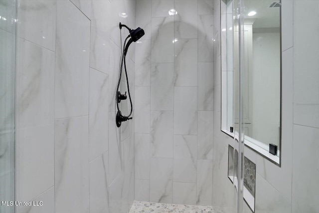 bathroom with tiled shower