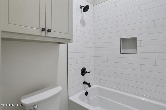 bathroom with tiled shower / bath combo and toilet