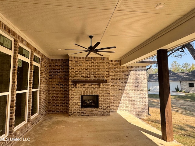 view of patio with an outdoor brick fireplace and ceiling fan