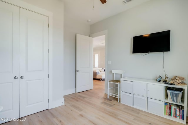 unfurnished bedroom featuring visible vents, light wood-style flooring, baseboards, and a closet