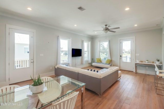 living room with a wealth of natural light, recessed lighting, visible vents, and light wood finished floors