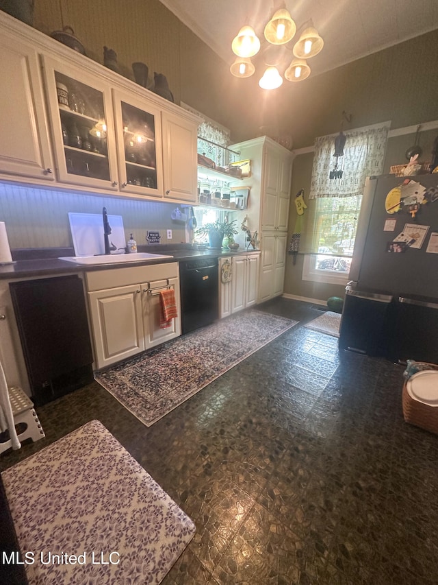 kitchen featuring white fridge, black dishwasher, an inviting chandelier, and white cabinets