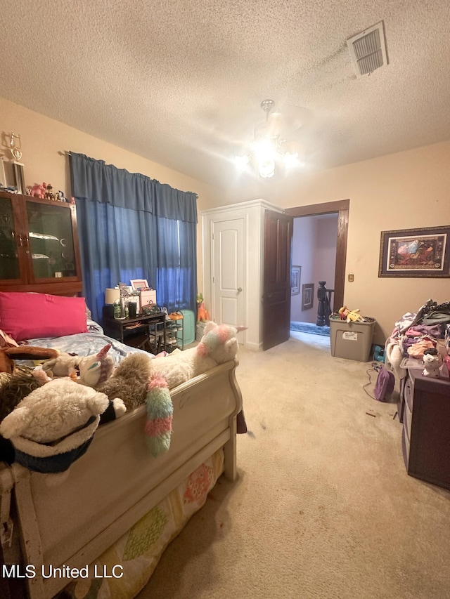 carpeted bedroom featuring a textured ceiling