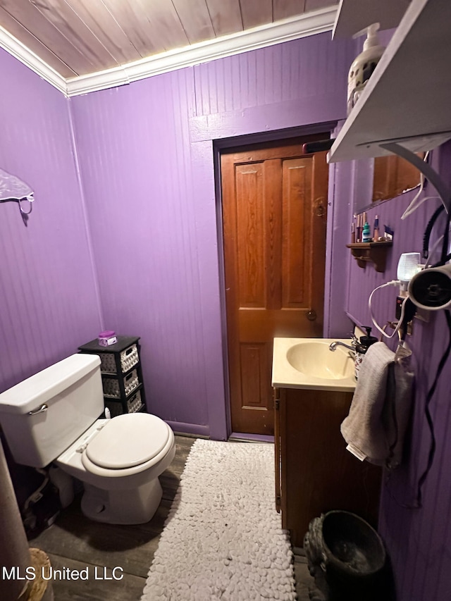 bathroom with vanity, ornamental molding, hardwood / wood-style flooring, and toilet