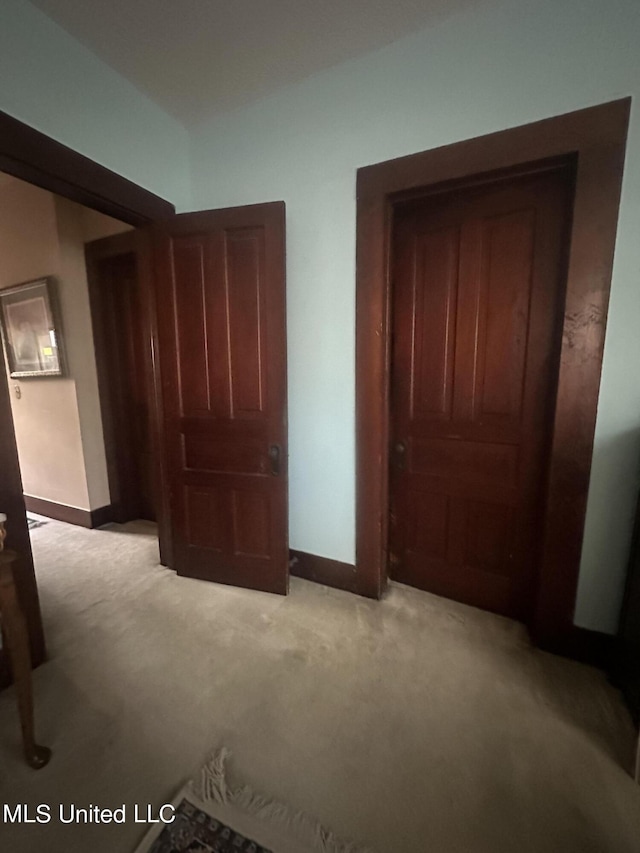 unfurnished bedroom with a closet and light colored carpet