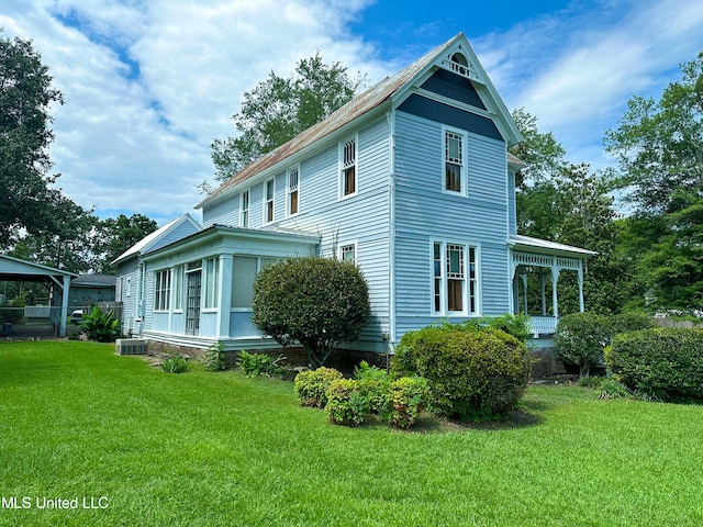 view of side of home with central air condition unit and a lawn