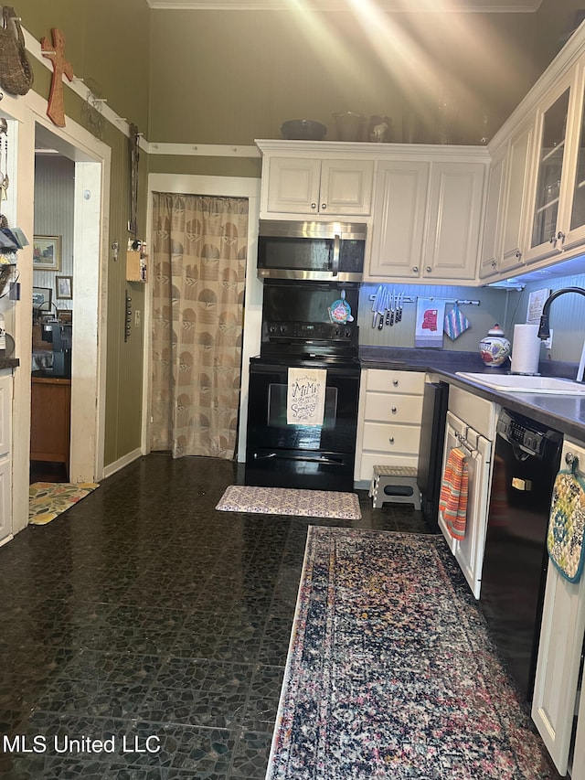 kitchen featuring white cabinetry, black appliances, and sink