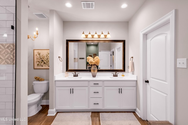 18109 Evergreen Dr, Gulfport, MS 39503 - full bathroom with double vanity, wood finished floors, recessed lighting, and tiled shower