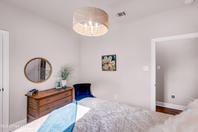 18109 Evergreen Dr, Gulfport, MS 39503 - bedroom featuring a chandelier and wood finished floors
