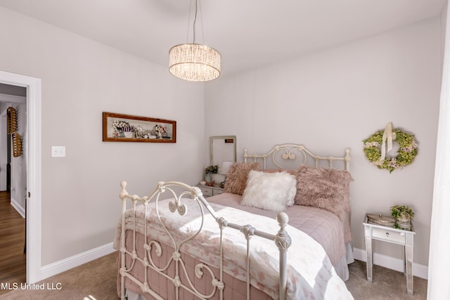 18109 Evergreen Dr, Gulfport, MS 39503 - carpeted bedroom with a chandelier and baseboards