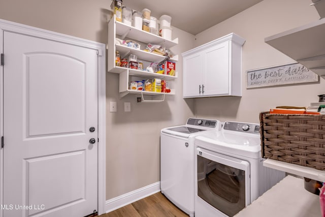 18109 Evergreen Dr, Gulfport, MS 39503 - laundry room with washer and dryer, cabinet space, and wood finished floors