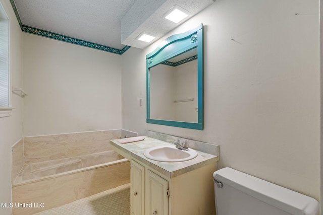 bathroom featuring vanity, a bath, and toilet