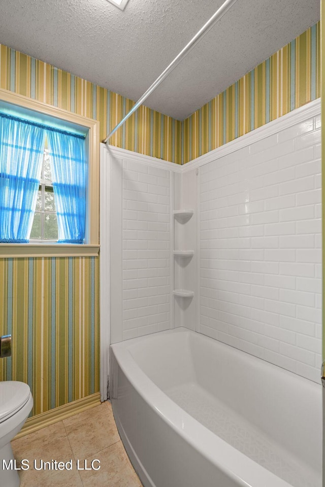 bathroom with toilet, a textured ceiling, wallpapered walls, and tile patterned floors