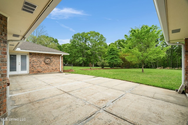 view of patio featuring french doors and visible vents