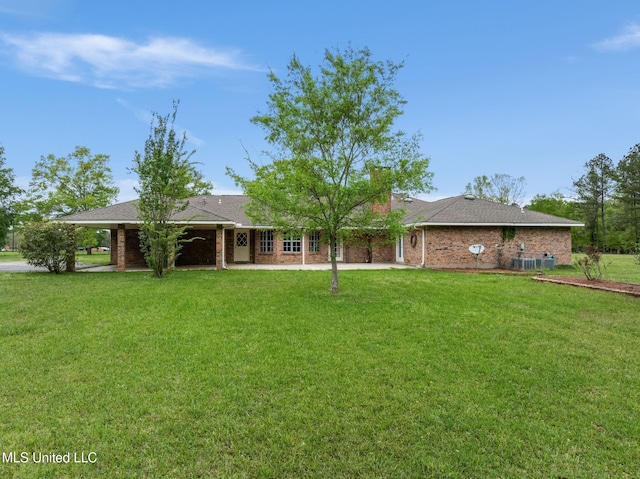 view of front of property with brick siding and a front lawn