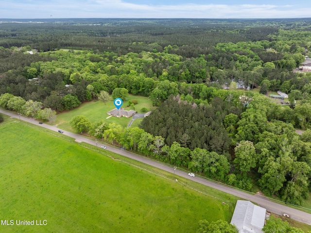 drone / aerial view with a wooded view