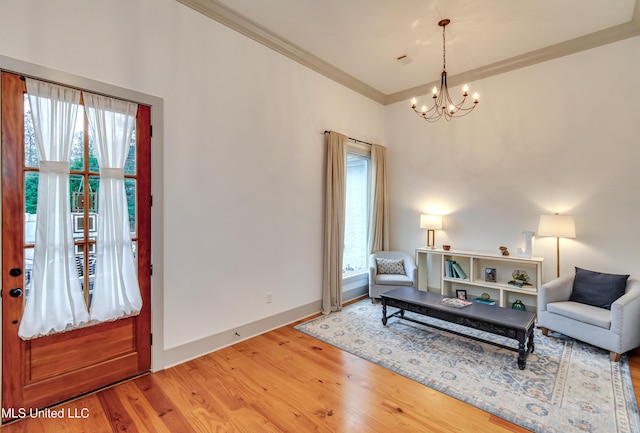 interior space featuring a chandelier, a healthy amount of sunlight, ornamental molding, and hardwood / wood-style flooring