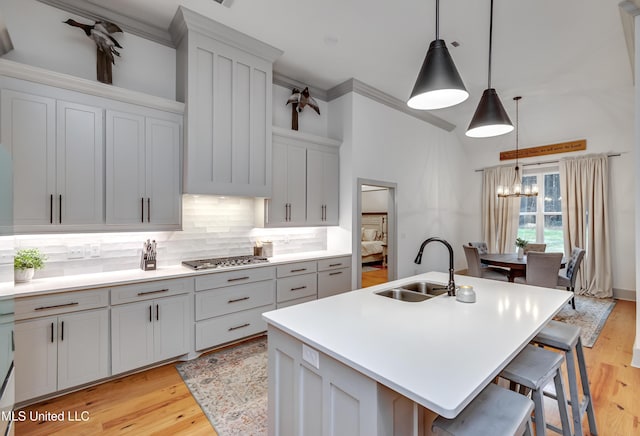 kitchen featuring sink, a breakfast bar area, and a center island with sink