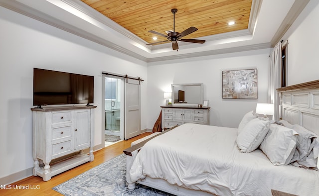 bedroom with wood ceiling, ceiling fan, connected bathroom, a tray ceiling, and light hardwood / wood-style flooring