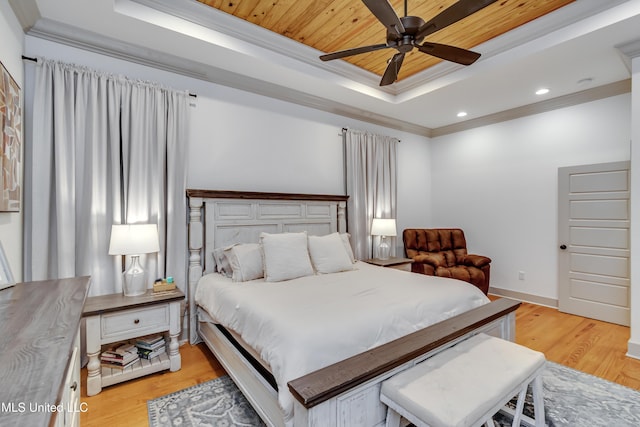 bedroom featuring ornamental molding, a raised ceiling, ceiling fan, wooden ceiling, and light hardwood / wood-style flooring