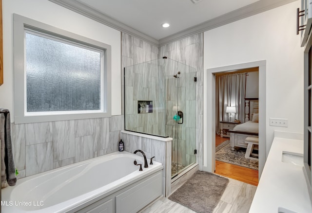 bathroom with ornamental molding and independent shower and bath