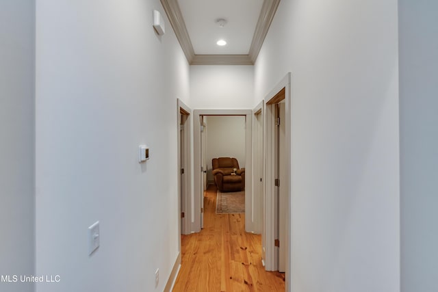 corridor featuring ornamental molding and light wood-type flooring