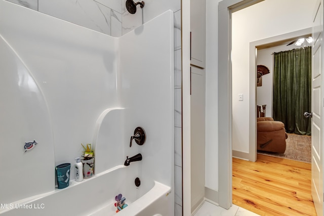 bathroom with ceiling fan, shower / bathtub combination, and hardwood / wood-style flooring