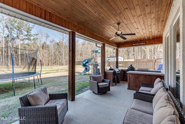 view of patio / terrace with a playground, a jacuzzi, and a trampoline