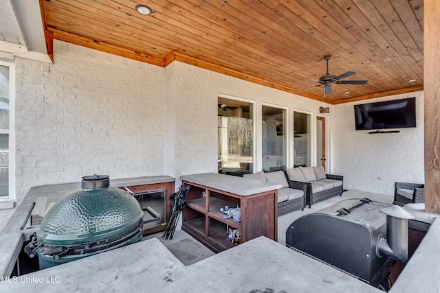 view of patio featuring ceiling fan, an outdoor living space, and area for grilling